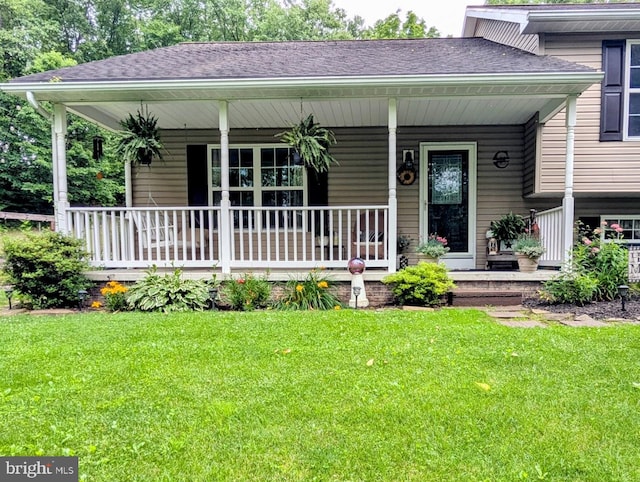 48 W 3rd St, Everett, PA 15537 - view of front of house with a porch, a front yard, and roof with shingles