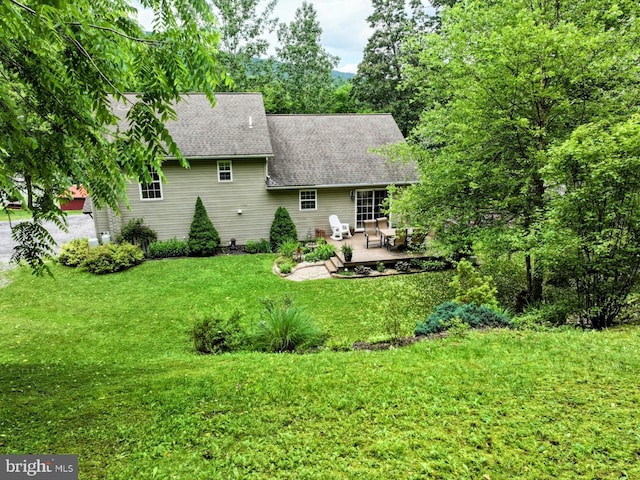 48 W 3rd St, Everett, PA 15537 - back of house with a patio area, roof with shingles, and a yard