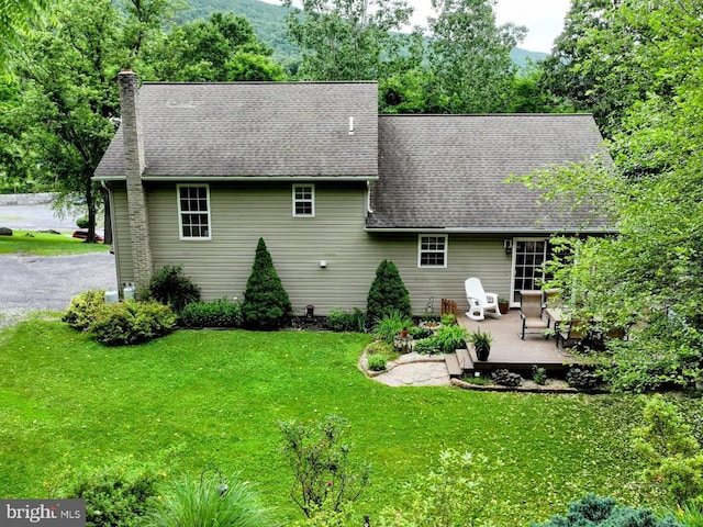 48 W 3rd St, Everett, PA 15537 - back of house featuring a lawn, a shingled roof, a chimney, and a deck