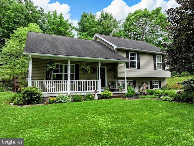 48 W 3rd St, Everett, PA 15537 - tri-level home with covered porch, a front lawn, and a shingled roof