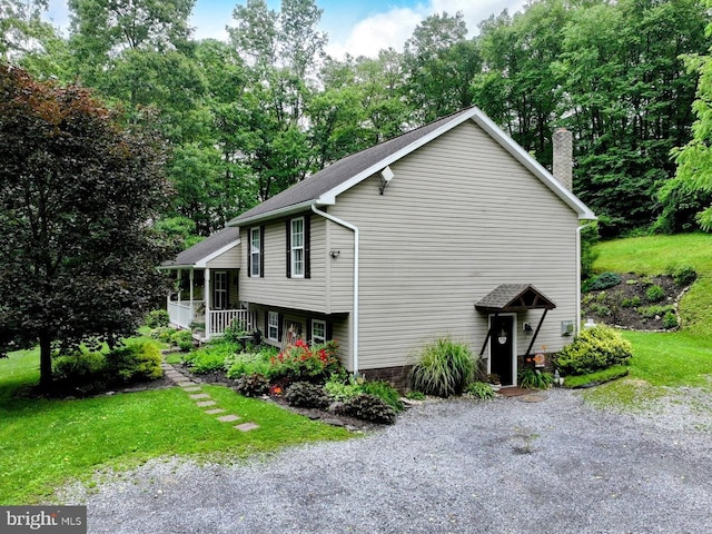 48 W 3rd St, Everett, PA 15537 - view of property exterior with a chimney, a yard, and view of scattered trees
