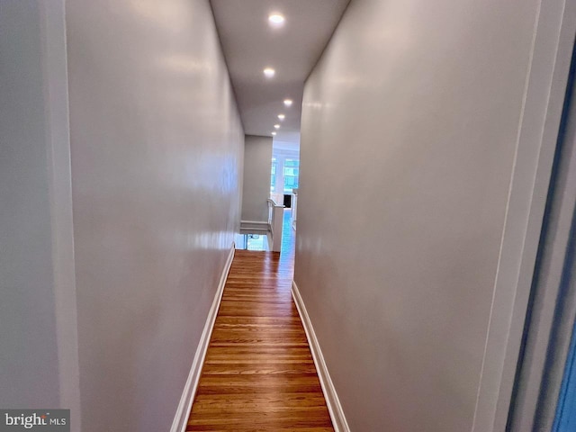 corridor with dark hardwood / wood-style floors