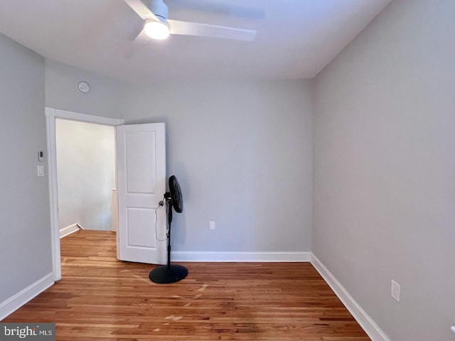 exercise room featuring ceiling fan and hardwood / wood-style flooring