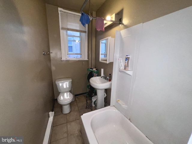 bathroom featuring tile patterned floors, tub / shower combination, and toilet