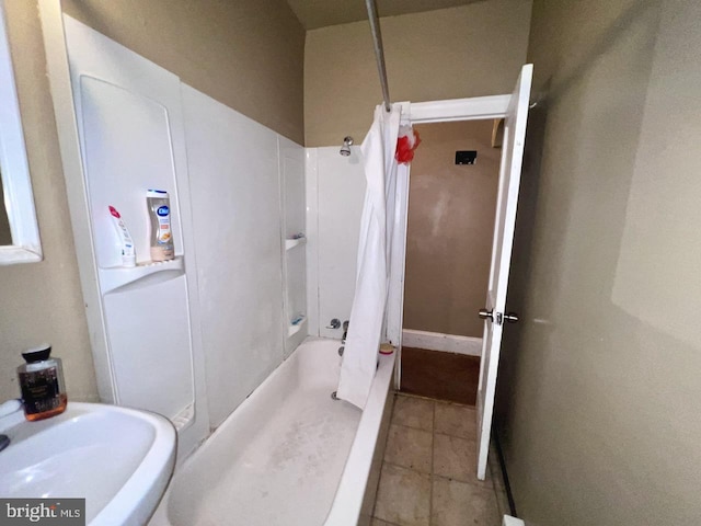 bathroom featuring shower / bath combination, tile patterned floors, and sink