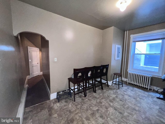 interior space with radiator heating unit and electric panel