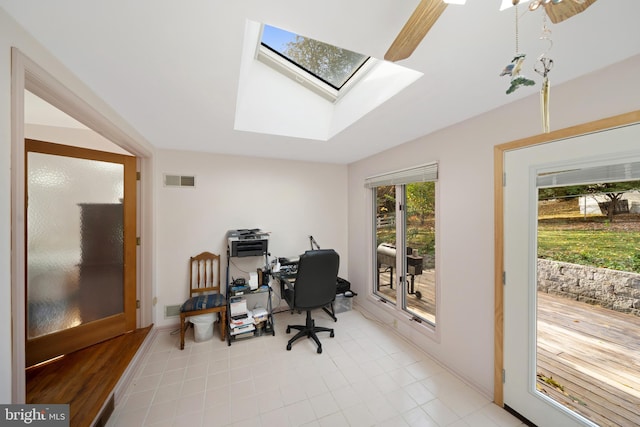 office area featuring visible vents, a skylight, and light tile patterned floors