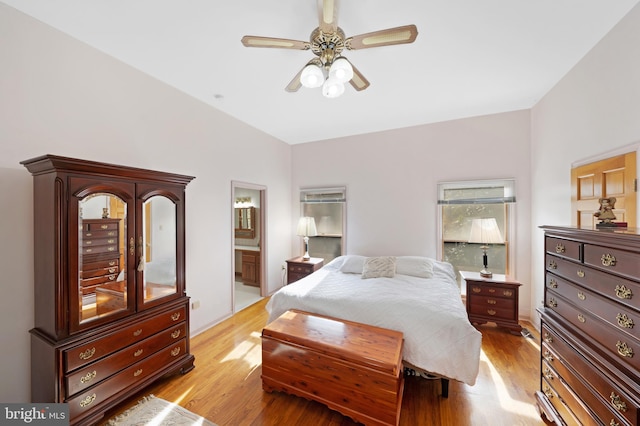 bedroom with ceiling fan, light wood-type flooring, and ensuite bath