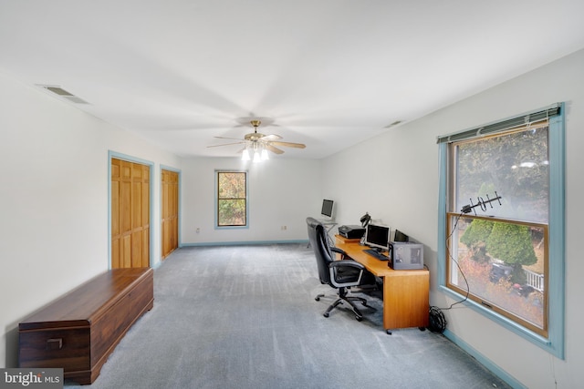 office area featuring baseboards, visible vents, a ceiling fan, and carpet flooring