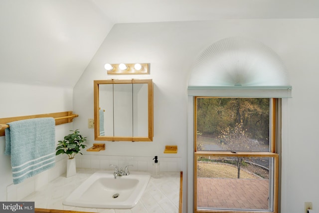 bathroom with sink and vaulted ceiling