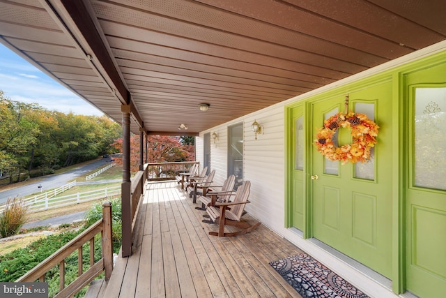 wooden terrace featuring covered porch