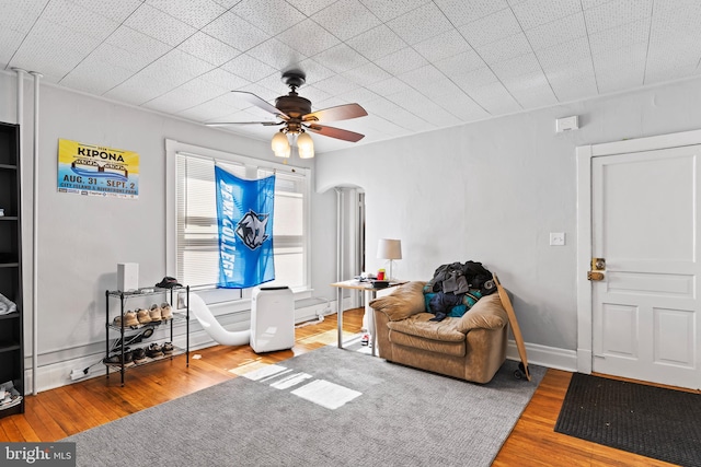 sitting room with wood-type flooring and ceiling fan