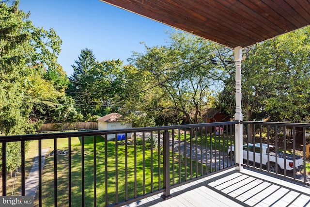 exterior space featuring a storage shed and a lawn