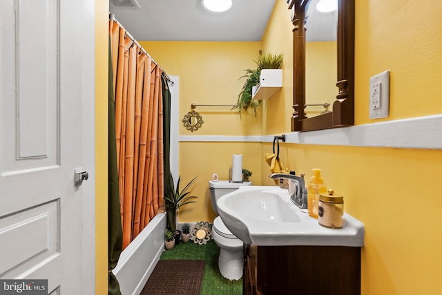 full bathroom featuring vanity, shower / bath combo with shower curtain, and toilet