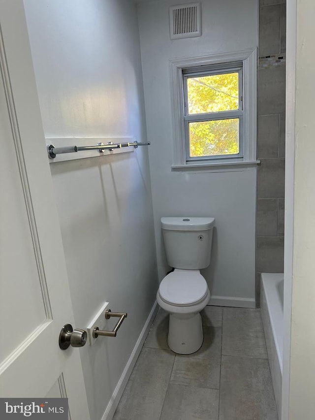 bathroom with separate shower and tub, toilet, and tile patterned flooring