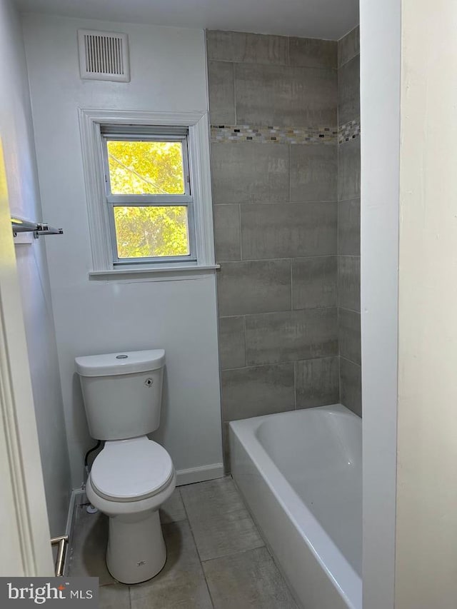 bathroom with toilet and tile patterned flooring