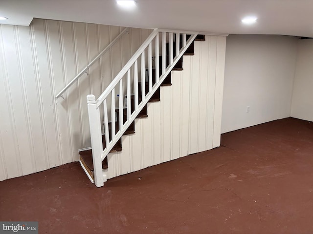 stairs with concrete flooring