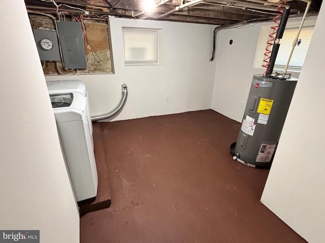 basement featuring water heater, electric panel, and separate washer and dryer