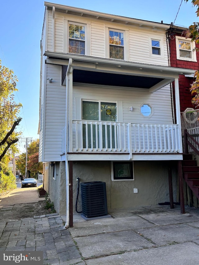 back of property featuring central air condition unit