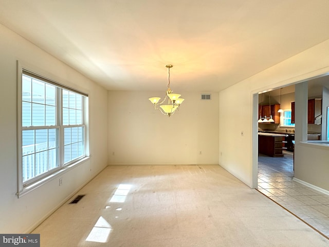 unfurnished dining area featuring light carpet and a chandelier