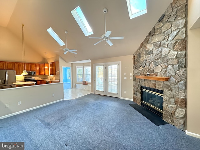 unfurnished living room with high vaulted ceiling, dark colored carpet, and a fireplace