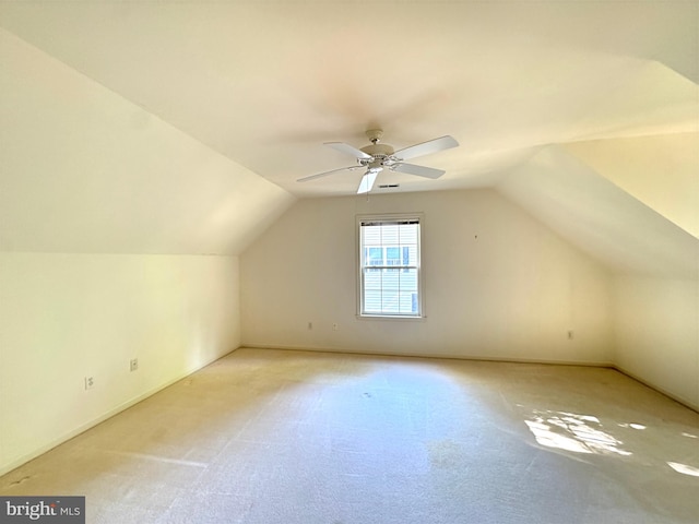 bonus room with light carpet, lofted ceiling, and ceiling fan