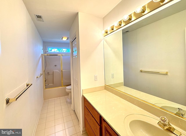 full bathroom with vanity, combined bath / shower with glass door, toilet, and tile patterned flooring