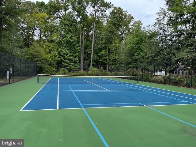 view of tennis court with basketball hoop