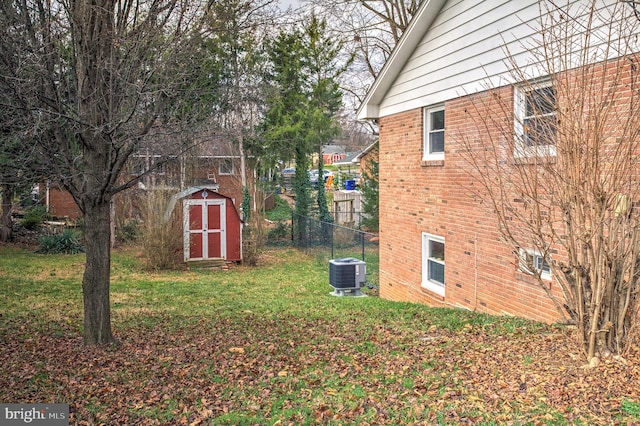 view of yard featuring a storage unit and central air condition unit