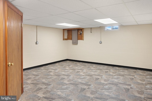 basement with a paneled ceiling