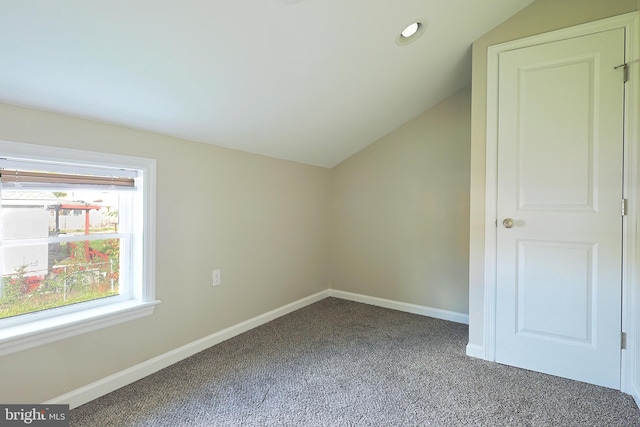 bonus room with carpet flooring and vaulted ceiling