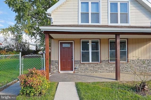 view of exterior entry featuring a yard