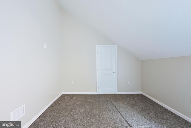 additional living space featuring carpet flooring and vaulted ceiling