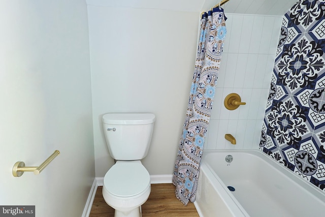 bathroom featuring shower / tub combo, hardwood / wood-style flooring, and toilet