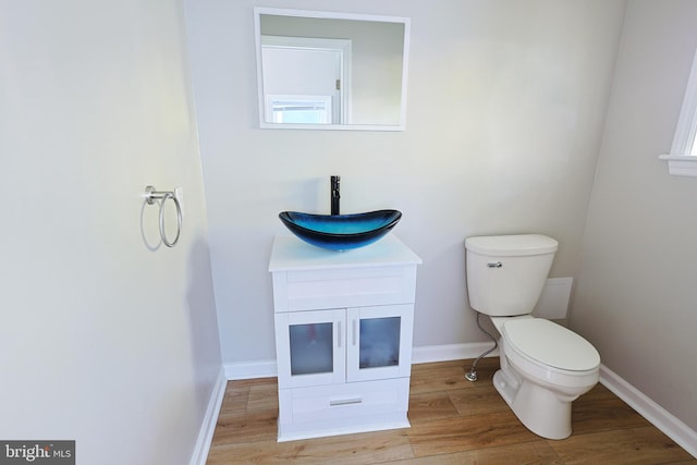 bathroom with vanity, hardwood / wood-style flooring, and toilet