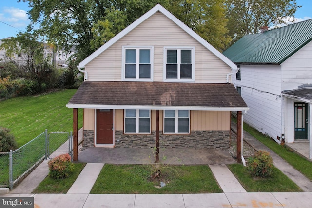 view of front of house with a patio area and a front lawn