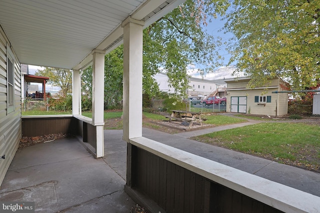 view of patio featuring a porch and a shed