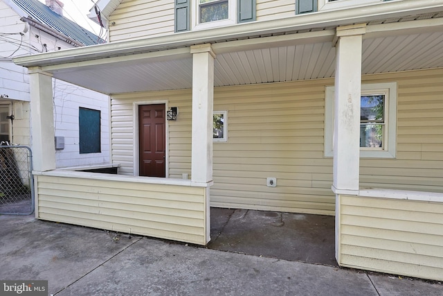 view of exterior entry with covered porch