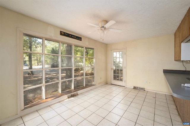 interior space with ceiling fan and a wealth of natural light