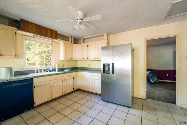 kitchen featuring stainless steel fridge, black dishwasher, sink, and light tile patterned floors