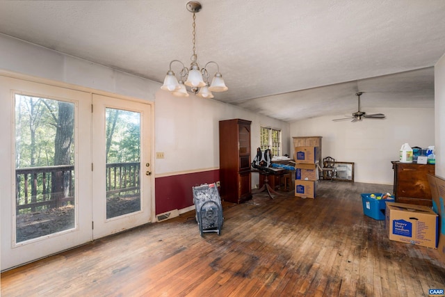 interior space with ceiling fan with notable chandelier, a textured ceiling, lofted ceiling, and dark hardwood / wood-style floors