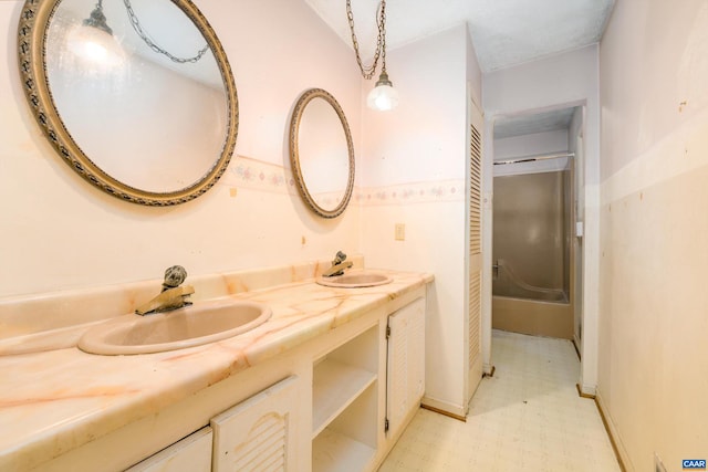 bathroom with vanity and a shower