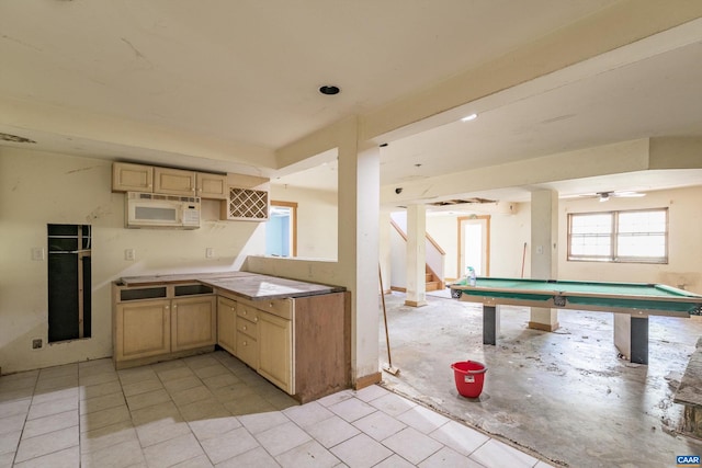 kitchen featuring pool table, ceiling fan, and light brown cabinets