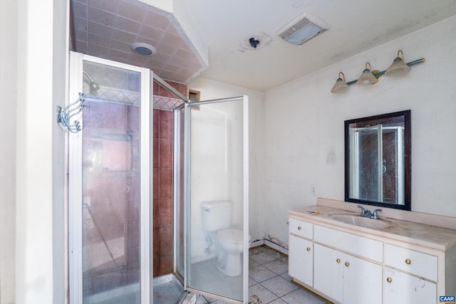 bathroom featuring tile patterned flooring, an enclosed shower, vanity, and toilet