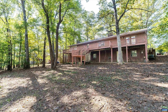 back of house featuring a wooden deck