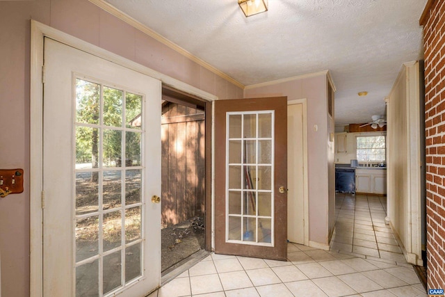 doorway featuring ceiling fan, crown molding, brick wall, light tile patterned floors, and a textured ceiling