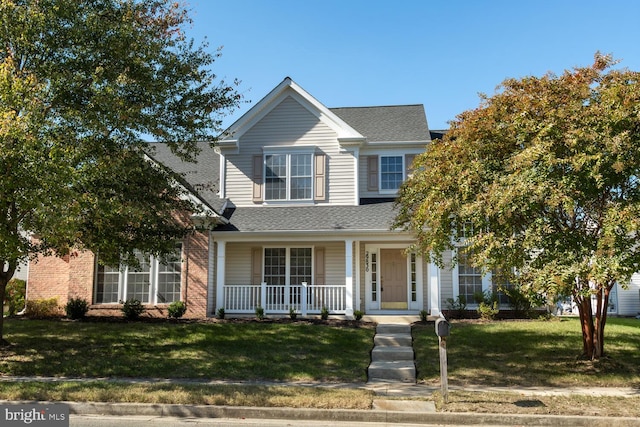 view of front of property featuring a front yard and covered porch