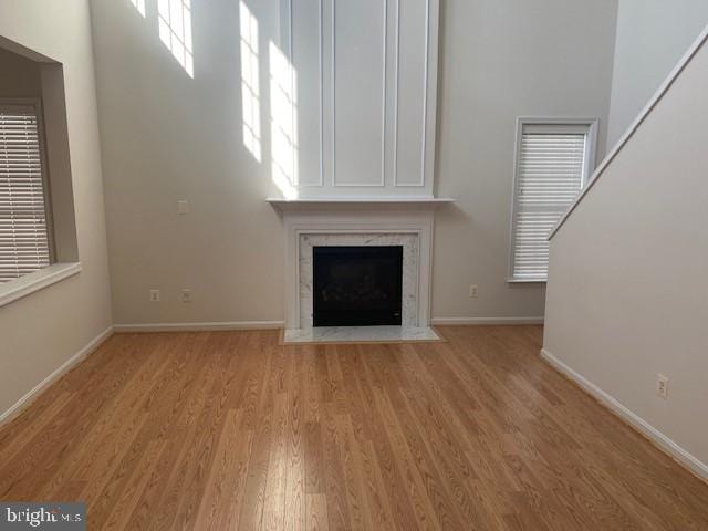 unfurnished living room featuring a fireplace and light hardwood / wood-style flooring