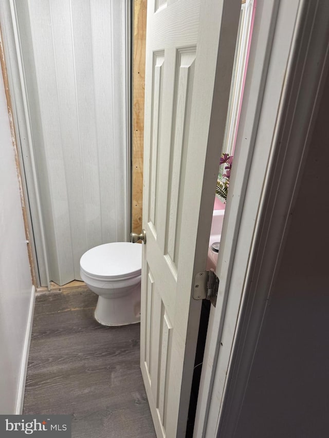 bathroom featuring hardwood / wood-style flooring and toilet