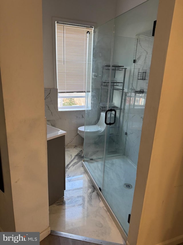 bathroom with vanity and a shower with shower door